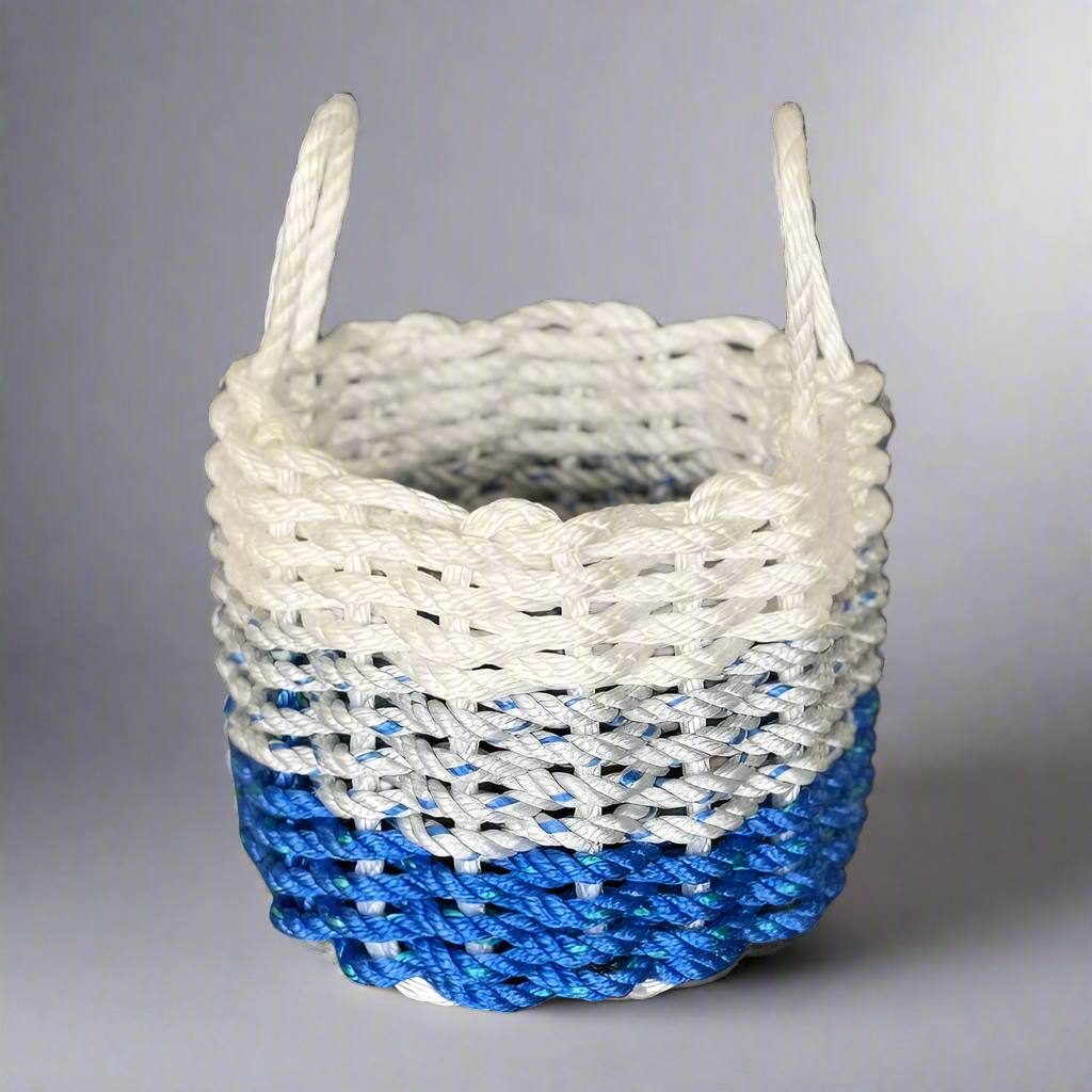 A handwoven lobster rope basket with white, grey, and blue colors, featuring a nautical design.
