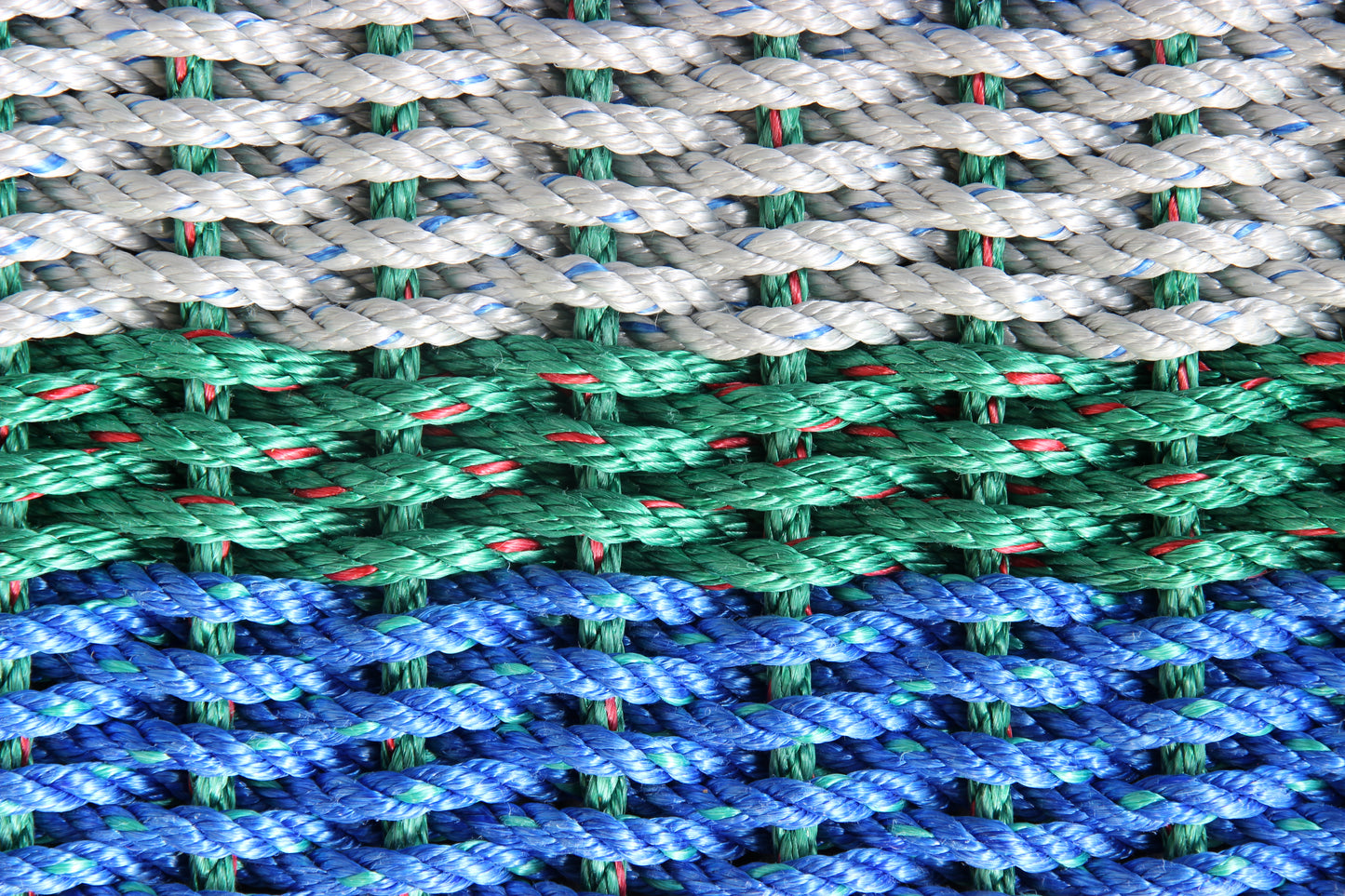 Close-up of multicolored rope with green, blue, and gray pattern