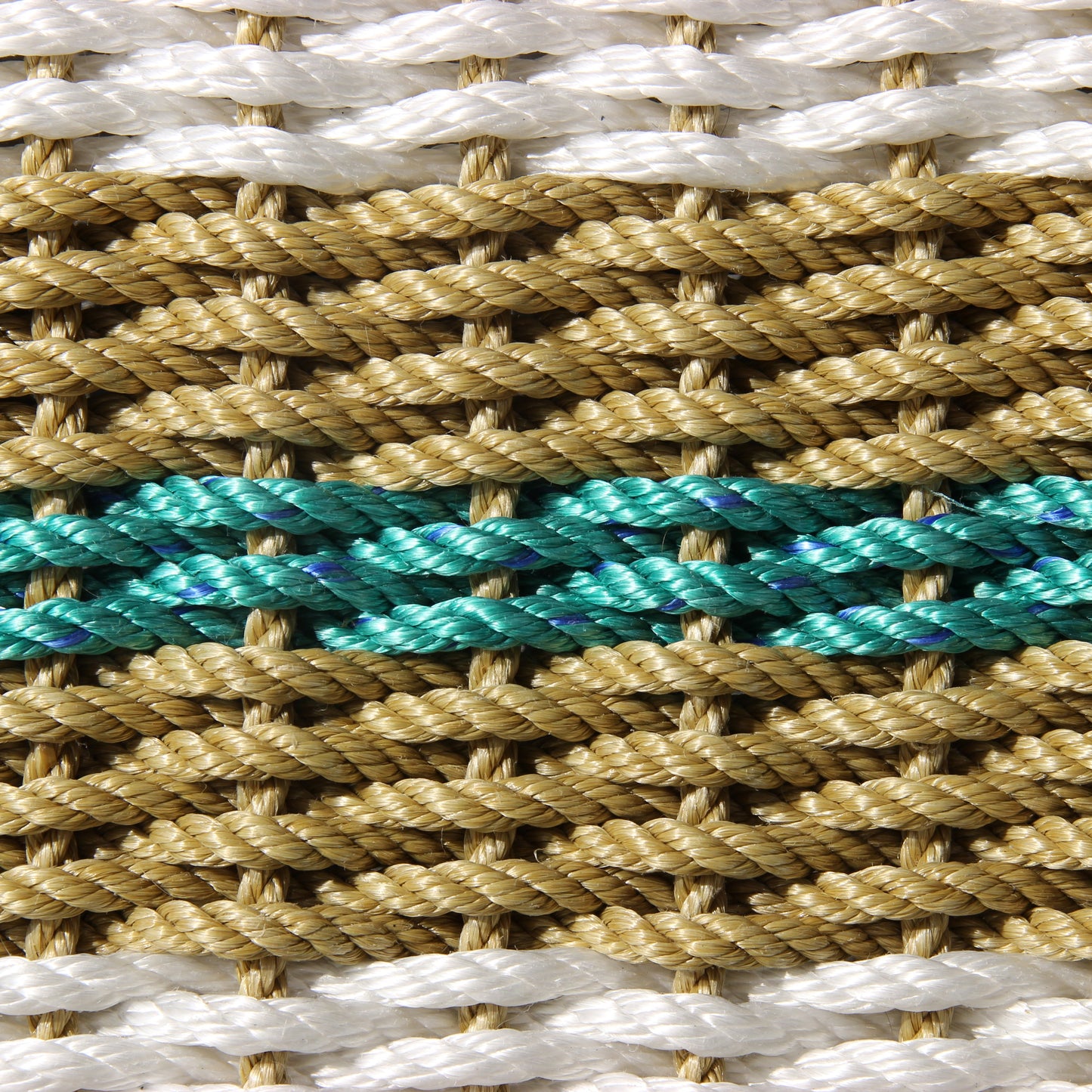 Close-up of handcrafted braided rope with white, tan, and teal strands.