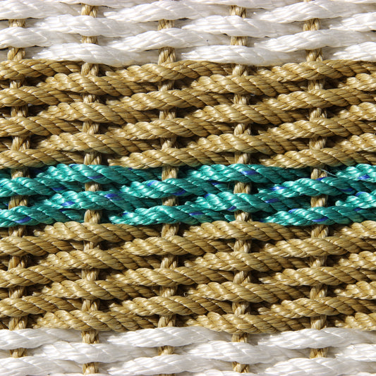 Close-up of handcrafted braided rope with white, tan, and teal strands.