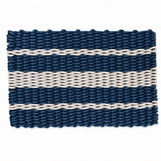 A rectangular woven placemat with horizontal stripes in dark navy blue and cream, shown flat against a white background.
