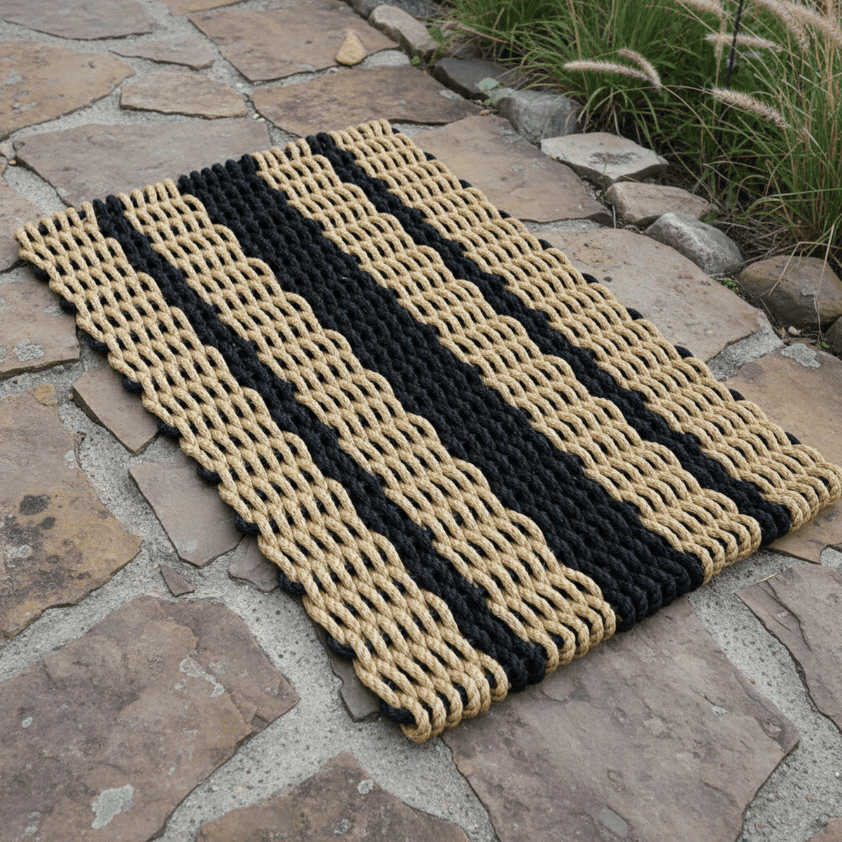 Tan & Black Lobster Rope Doormat outside on brick paver