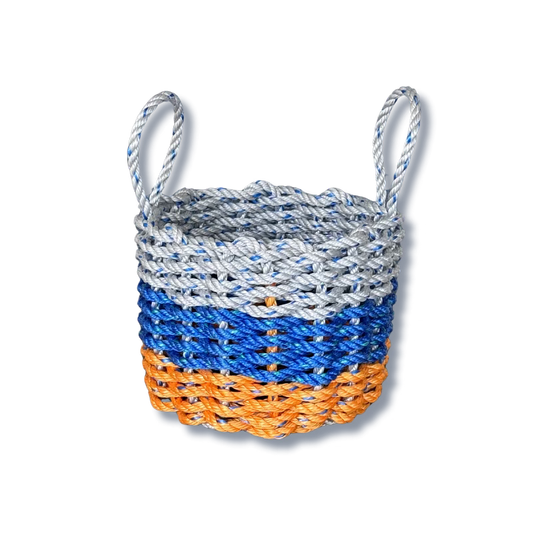 Woven basket with blue, orange, and gray pattern on a white background