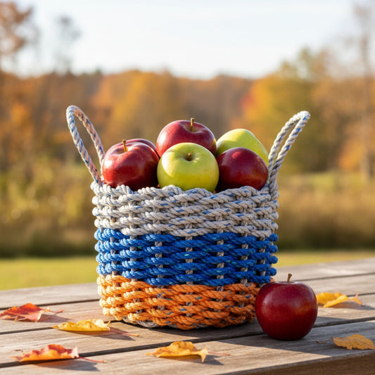 Woven basket with apples on a picnic table outdoors