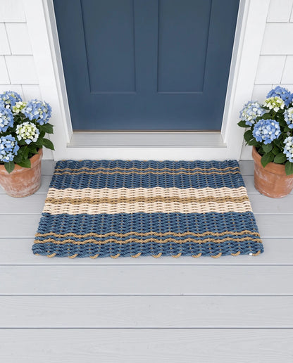 The Admiral lobster rope doormat showing its blue, tan and sand palette in an outdoor setting.