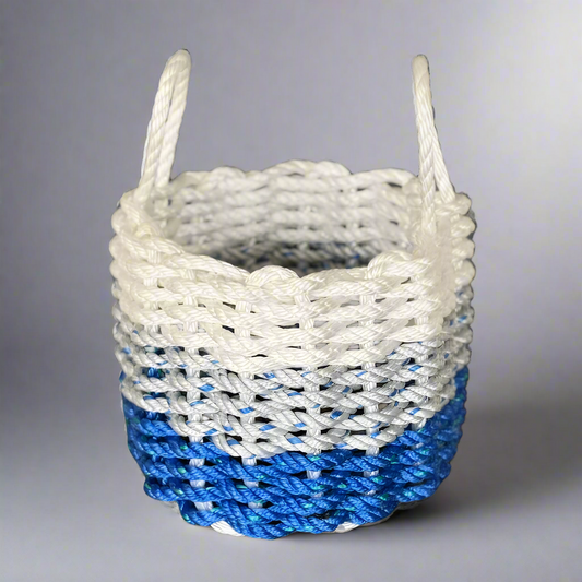 A handwoven lobster rope basket with white, grey, and blue colors, featuring a nautical design.
