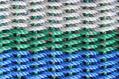 Close-up of multicolored rope with green, blue, and gray pattern